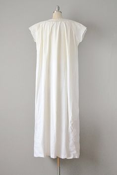 "This Victorian night gown is made from soft, off-white cotton in a beautiful, simple design. The top has a yoke of crocheted cotton lace, with a rounded, drawstring collar. Dolman-like sleeves transition into the straight cut skirt of the piece. Would look great belted, or on its own as a summer day look. Pullover fit. Size: M, L, XL. Bust: 52\" Waist: 56\" Hips: 56\" Length: 58\" Label: None. Condition: Excellent vintage condition (tiny pin-hole near front hem). All vintage is sold in \"as-is\ White Cotton Home Dress, White Cotton Dress For Home, White Cotton Dress For Loungewear, White Relaxed Fit Nightgown For Sleep, White Cotton Nightgown Relaxed Fit, White Cotton Relaxed Fit Nightgown, White Relaxed Fit Sleep Dress, 1800s Dresses Victorian, Lace Chemise