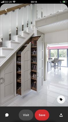 an open closet under the stairs in a house