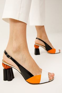 Materials Upper: LeatherLining: LeatherSole : Leather MEASUREMENTS Heel height: 3.5” Rize Multicolor Pumpkin Heel Leather Women Sandal: A Playful Harmony of Black & Orange Harmony of Black and Orange: The Rize Multicolor Pumpkin Heel Leather Women Sandal beautifully combines the classic allure of black with the vibrant energy of orange, creating a harmonious and eye-catching design. Artisanal Craftsmanship: Meticulously handcrafted from 100% genuine calf leather, this sandal showcases unparallel Unique Shoes, Black And Orange, Bold Fashion, Black Orange, High Quality Leather, Orange Black, Comfortable Shoes, Leather Shoes, Calf Leather