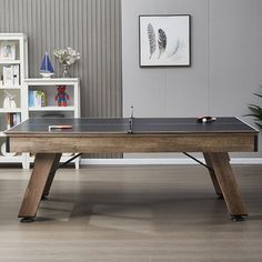 a ping pong table in the middle of a living room