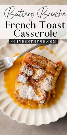 french toast casserole on a white plate with powdered sugar and orange syrup