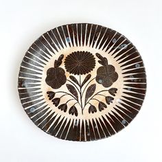 a black and white plate with flowers on it