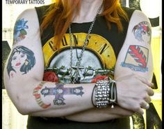 a woman with red hair and tattoos on her arms