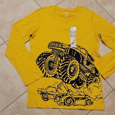 Yellow Long Sleeve Tee With A Monster Truck. Size 14 -16. Brand New. Yellow Long Sleeve Top With Character Print, Long Sleeve Graphic Tee With Character Print, Truck Top, Dino Shirt, Floral Long Sleeve Shirt, Boys Long Sleeve Shirts, Carter Kids, Yellow Long Sleeve