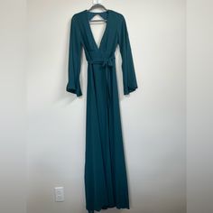 This Beautiful Maxi Dress From Show Me Your Mumu Features Flared Sleeves, A V-Neckline, And A Zip Closure. It Comes In A Stunning Teal Color And Is Made From Chiffon Fabric. The Dress Is Perfect For Any Occasion, Whether It's A Wedding, Party, Or Formal Event. The Long Sleeve Dress Has A Bohemian Theme And Is Suitable For All Seasons, Including Winter, Summer, Fall, And Spring. It's A Size S And Is Ideal For Regular-Sized Women. The Dress Length Is Long, Making It Elegant And Graceful. The Brand Blue Maxi Length V-neck Party Dress, Blue V-neck Maxi Dress With Tie Back, Formal V-neck Maxi Dress With Tie Back, Blue Surplice Neckline Maxi Dress For Evening, Blue Maxi Dress With Surplice Neckline For Evening, Blue Maxi Length V-neck Dress For Party, Flowy Backless Formal Dress, Formal V-neck Tie-back Maxi Dress, Date Night Dress With Surplice Neckline And Tie Back