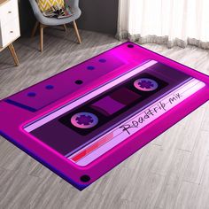 a pink rug with a purple cassette tape on it