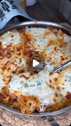 a pan filled with pasta and cheese on top of a table