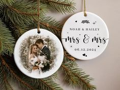 an ornament hanging from a christmas tree with a couple's photo on it