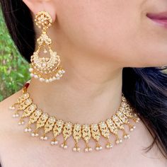 Featuring a jadau necklace matched with a pair of long chanbali style earrings. It has been embellished with precious freshwater pearls. The necklace is supplied with a fancy tassel/dori and the earrings close with a bombay screw. Elegant Kundan Necklace With Latkans For Diwali, Elegant White Kundan Necklace With Latkans, Elegant Pearl Necklace With Latkans For Diwali, Elegant Pearl Necklace With Latkans For Festive Occasions, Elegant White Temple Necklace With Latkans, Elegant Pearl Necklace With Latkans For Festivals, Elegant Kundan Necklace With Latkans For Festivals, Elegant Chandbali Kundan Necklace With Latkans, Festive Chandbali Bridal Necklace With Pearl Drop