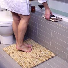 a person standing over a toilet in a bathroom