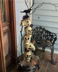 a bunch of skulls are stacked on top of each other in front of a house