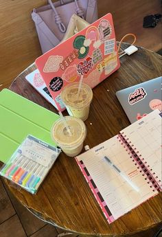 a wooden table topped with notebooks and other items