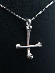 "Silver bone cross necklace, sterling silver round venice chain included. This handmade dark art gothic cross is made from 925 sterling silver with oxidated details. Each piece is made to meet customers desires, so let me know if you want something special included your very own version. Golden version is possible also! Pendants first class finish has a lifetime guarantee and it will be renewed when needed with a cost of postage.  Jewelry will be sent with FedEx International Economy, shipment is included in the price of jewelry. Upgrade to FedEx International Priority for even faster shipment. You can choose between five different finish: 'Polished' has darkened details and polished finish. 'Matte' has darkened details and matte finish. 'Bright white' is polished and details are left brig Gothic Sterling Silver Crucifix Necklace, Gothic Sterling Silver Cross Necklace, Upside Down Cross Necklace, Petrine Cross, Black Metal Necklace, Upside Down Cross, Gothic Cross, Gothic Crosses, Saint Peter