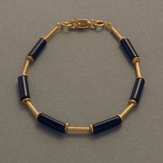 This  gemstone bracelet features an attractive contrast between gold-plated silver and matte-polished Onyx stones. The elongated shape of the individual elements make this bracelet a very harmonious and elegant piece of jewellery. Because of its subtle color combination, this bracelet can be worn for any occasion with almost any color and fabric. The bracelet looks nice alone, but also ideally complements the Onyx necklace and matching earrings from the same collection. These can also be ordered Elegant Metal Bracelets With Natural Stones, Modern Gold Bracelets With Natural Stones, Formal Gold Bracelets With Natural Stones, Elegant Metal Beaded Bracelets With Natural Stones, Crystal Bead Jewelry, Onyx Necklace, Onyx Bracelet, Jewelry Online Shopping, Onyx Stone