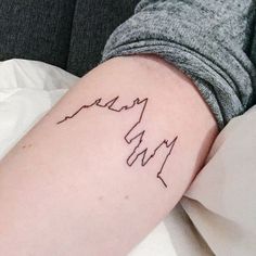 a woman's arm with a tattoo on it that has the word love written in cursive writing