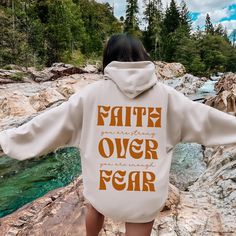 Get ready to be OBSESSED with your new favorite Faith Over Fear hoodie! It's the cutest and most trendy way to emit all those positive saying vibes to wear as a helpful reminder that You Are Strong and You Are Enough! Crafted from the softest fabric, this Gildan 18500 hoodie ensures the utmost comfort throughout the day. * Q U I C K F A C T S * ✺ 50% Cotton, 50% Polyester ✺ Wash and dry on delicate, inside out (on cool for best results) * S I Z I N G * ✺ Models are wearing size Large ✺ Sizing is Inspirational Hoodie For Fall Streetwear, Fall Slogan Hoodie For Loungewear, Inspirational Fall Streetwear Hoodie, Inspirational Letter Print Hoodie For Fall, Inspirational Hoodie Sweatshirt For Fall, Inspirational Hooded Sweatshirt For Fall, Inspirational Fall Hoodie Sweatshirt, Inspirational Hooded Fall Sweatshirt, Inspirational Graphic Print Hoodie For Fall