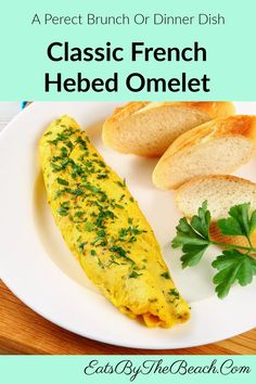 a white plate topped with an omelet and bread