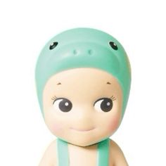 a small toy with a green hat on top of it's head and eyes