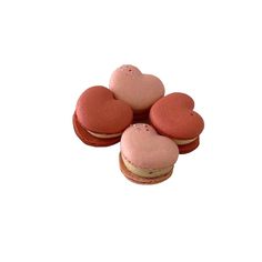 four macaroons are arranged in the shape of hearts on top of each other