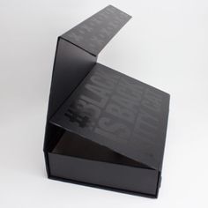 an upside down black box sitting on top of a white surface with the words inside it