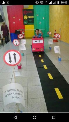 a child's birthday party with cars and signs on the floor in front of them