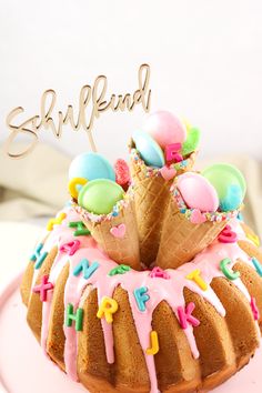 a bundt cake with icing and decorations on top that says happy birthday next to an ice cream cone