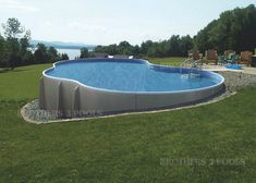 an above ground swimming pool in the middle of a grassy area with lawn chairs around it