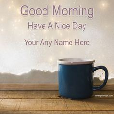 a blue coffee cup sitting on top of a wooden table next to a white wall