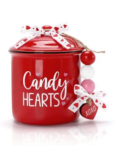 a red candy jar with white and red decorations on the lid that says candy hearts