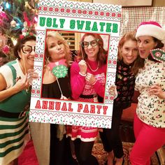 three women are posing for a photo in front of a christmas tree with ugly sweaters on