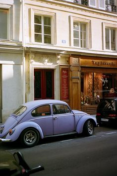 two cars parked in front of a building