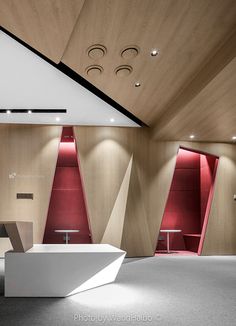 the interior of a modern bathroom with red and white accents on the walls, along with an oval shaped bathtub