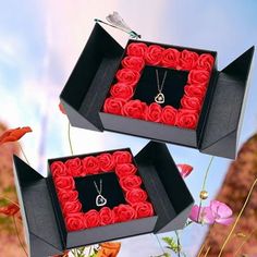 two black boxes with red roses in them, one is open and the other is closed