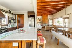 a large kitchen with an island and wooden ceiling