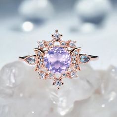 a ring with an amethorate surrounded by blue and white diamonds on top