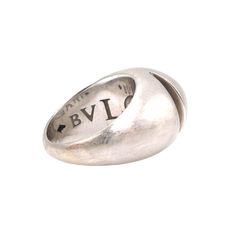 This vintage Bulgari ring is from their "Cabochon" line. Named after a cut of stone that's polished without being faceted, the top of this piece is designed to resemble an oval, cabochon gem. Two carved recesses beneath the top add a further sense of three dimensional art, and the wide shank tapers from 14mm to 3.5mm. The inside of the ring is deeply engraved with "BVLGARI" in graduated lettering. Stamped "585" in a diamond, which is the hallmark for 14 karat gold. DETAILS ____________________ M Luxury Domed Cabochon Rings, Classic Domed Cabochons With Polished Finish, Classic Round Hallmarked Cabochons, Classic White Gold Cabochons For Anniversary, Classic Oval Cabochons For Anniversary, Vintage Oval Cabochons For Formal Occasions, Classic Oval Gemstone Cabochons, Luxury White Gold Oval Cabochons, Classic Silver Polished Cabochons