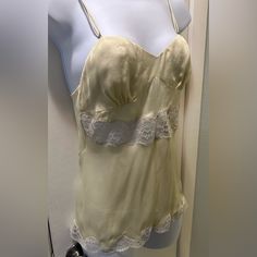 Beautiful Light Yellow And White Lace 100% Silk Camisole With Adjustable Straps And Buttons Down The Back. New With Tags, However There Is Some Light Snagging On The Bust Area (As Seen In The Last Pic). However, It Is Barely Noticeable And Can Possible Be Shaved Off? Italian Size 40, Which Is A Us Size Medium I’m Trying To Sell Most Of My Belongings So I Can Move Out Of The Country. So Feel Free To Make Me An Offer! However, Please Remember, All Sales Are Final. Thank You! Questions? Leave A Com Vintage Summer Top With Built-in Bra, Yellow Tank Top With Built-in Bra For Spring, Cream Camisole With Built-in Bra And Spaghetti Straps, Vintage Sleeveless Top With Built-in Bra, Yellow Sleeveless Top With Lace Trim, Spring Cream Tank Top With Built-in Bra, Beige Camisole Tank Top For Daywear, Yellow Lace Trim Sleeveless Top, Cream Camisole With Adjustable Spaghetti Straps