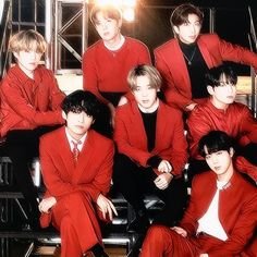 the group of young men are posing for a photo in their red suits and ties