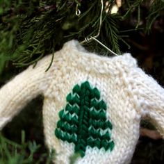 a knitted christmas ornament hanging from a tree