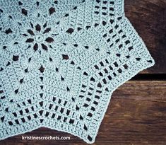 a crocheted doily sitting on top of a wooden table