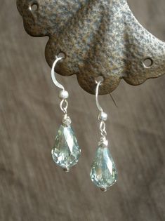 Faceted, pale green Austrian glass crystal teardrops dangle strikingly from sterling silver French ear wires, measuring 1 and 1/4 inches in length. Light and light-catching! Suitable for sensitive skin; silicone ear backs included. Gift-packaged and ready for giving or wearing! With warm thanks, Deanna Ross Owner and Designer, Spirit Arts Jewelry Handmade in Monterey, California Green Sterling Silver Teardrop Earrings Hypoallergenic, Green Sterling Silver Teardrop Earrings, Sterling Silver Drop Crystal Earrings, Sterling Silver Drop Crystal Earrings With Ear Wire, Sterling Silver Teardrop Crystal Earrings With Ear Wire, Silver Briolette Crystal Earrings With Ear Wire, Sterling Silver Teardrop Crystal Earrings, Silver Drop Crystal Earrings With Ear Wire, Silver Teardrop Crystal Earrings With Ear Wire