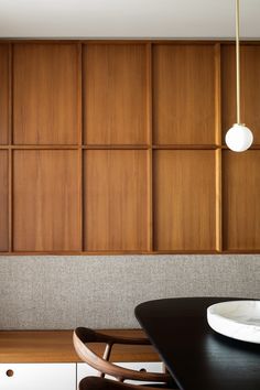 a dining room with wooden paneling on the wall