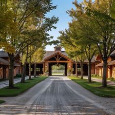 an empty road with trees lining both sides and a building on the other side in the distance