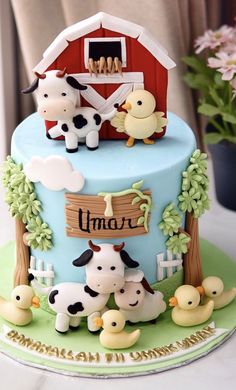 a blue cake with farm animals on it