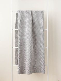 a white towel is hanging on a rack