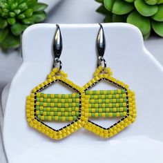 Length: 3.25 Inches Width: 1 Inches Lemon-Lime (#148) These Handmade Earrings Feature Vibrant Yellow And Green Glass Seed Beads Arranged In A Geometric Hexagon Pattern, Giving A Fresh And Modern Look. The Sleek Silver-Tone Ear Hooks Add A Touch Of Elegance To Balance The Bold, Playful Colors. Perfect For Adding A Pop Of Color To Any Outfit These Earrings Are Lightweight And Eye-Catching, Ideal For Casual Days Or A Fun Night Out! Perfect Accessory For A Concert Cruise Gift Birthday Anniversary Christmas Vacation Ask Me About Custom Orders Caring For Your Handmade Jewelry All Metals Can Tarnish Over Time, So Proper Care Is Essential After Wearing Your Piece, Clean It With The Cruise Gifts, Playful Colors, Earring Wires, Earring Ideas, Hexagon Pattern, Glass Seed Beads, Christmas Vacation, Yellow And Green, Brick Stitch