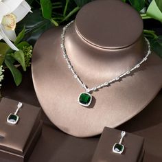 Enhance your ensemble with this exquisite Green Cubic Zirconia Pendant Necklace Earrings Set. Designed with precision, this set features: Main stones: AAA+ grade White Cubic Zirconia for stunning brilliance Metal: High-quality Copper with a White Gold color for an elegant look Eco-Friendly: Lead & Nickel Free for peace of mind Package: Comes in a stylish Gift Box, perfect for gifting Style: Square shape/pattern for a modern and chic appeal Elevate your style and make a statement with this elegan Elegant Green Cubic Zirconia Necklaces, Luxury Green Pendant Jewelry Sets, Elegant Emerald Square Pendant Jewelry, Elegant Green Square Pendant Jewelry, Silver-colored Cubic Zirconia Emerald Necklace, High Jewelry Design, Antique Gold Earrings, Diamond Jewelry Set, Big Necklace