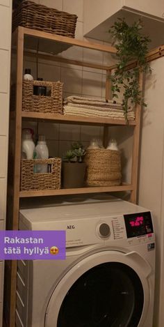 a washer and dryer in a small room with shelves on the wall above them