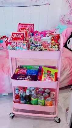 a pink cart filled with candy and snacks