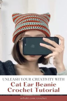 a woman taking a selfie with her cat ear beanie crochet hat